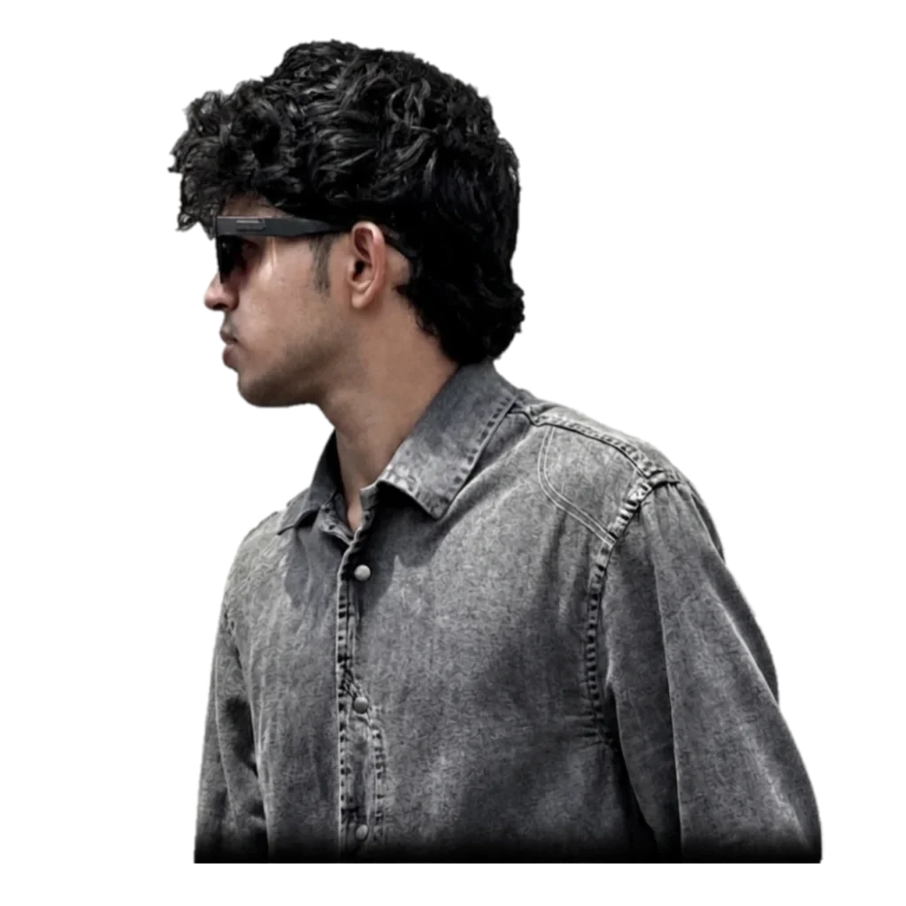 "Image of a young professional, potentially the best digital marketing freelancer in Malappuram, wearing a black jacket and sunglasses against a dark background."