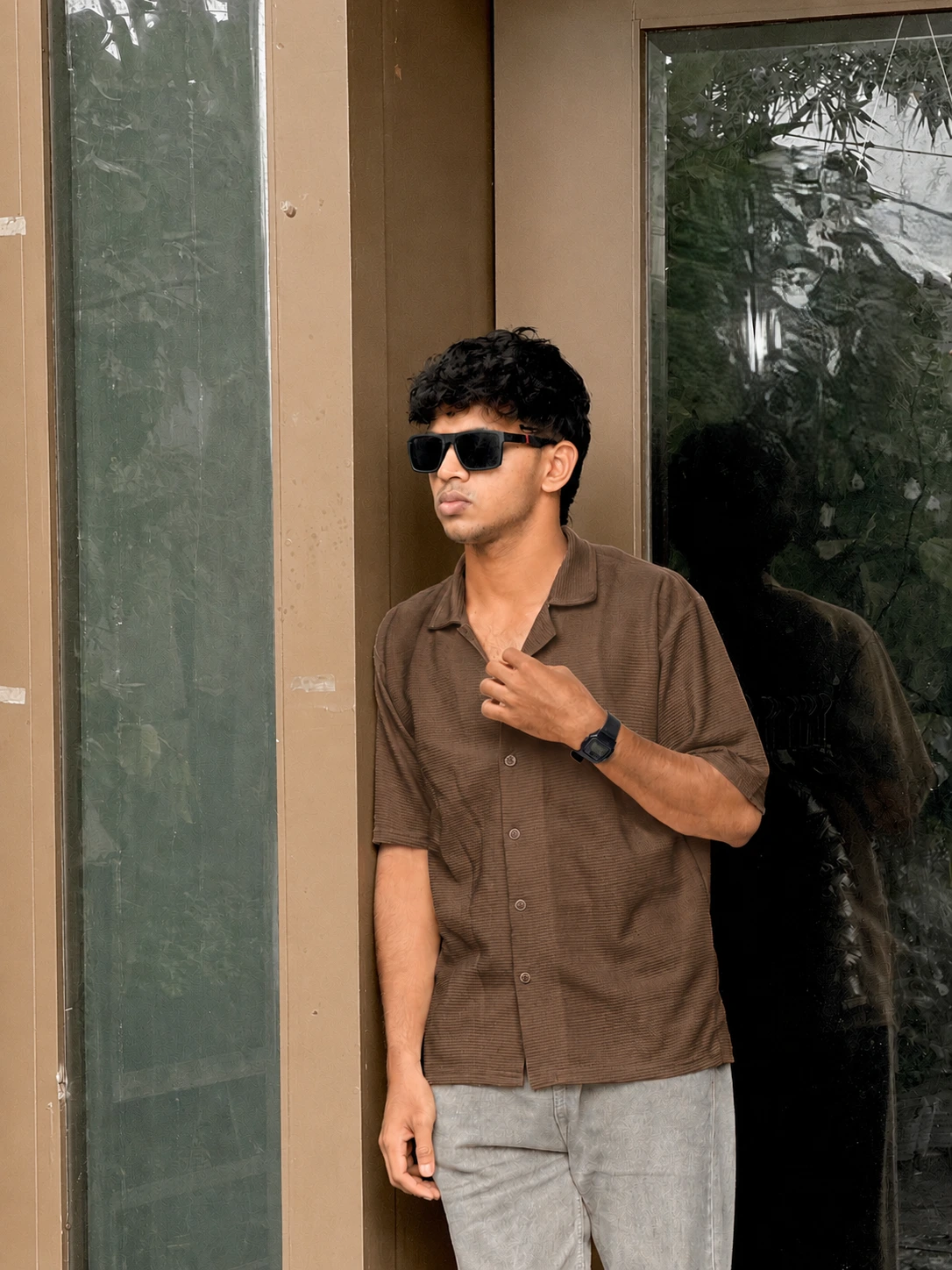 "Image of a young professional, potentially the best digital marketing freelancer in Malappuram, wearing a black jacket and sunglasses against a dark background."